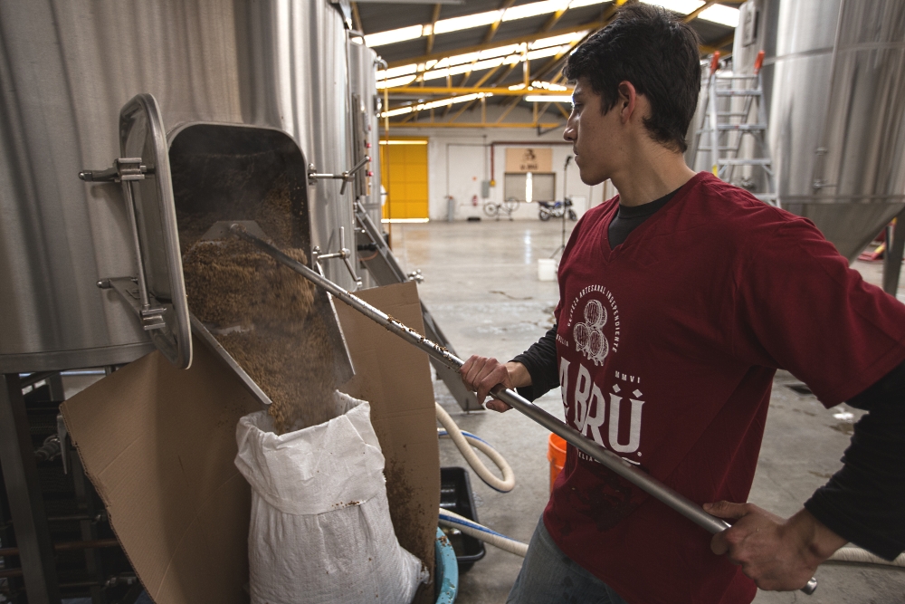 Brewmaster Ernesto Herrera Removing Steaming Spent Grain from Cerveceria La Bru's PKW Brewhouse